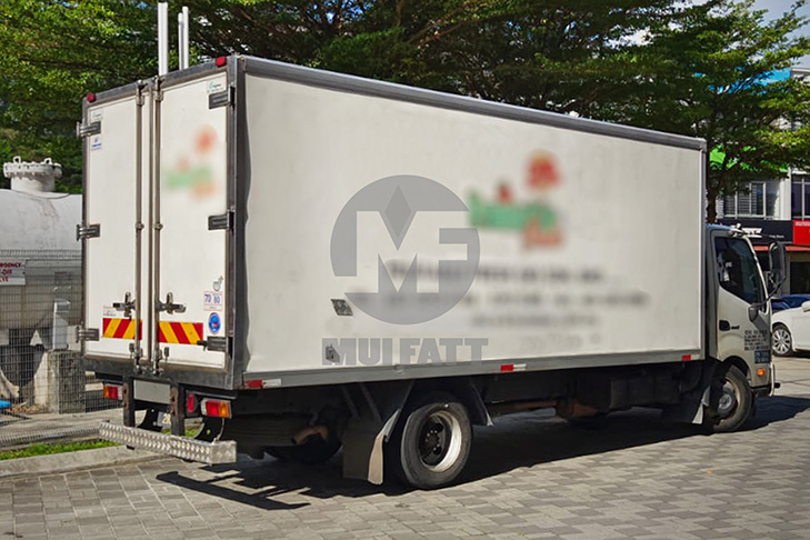 Cold truck with rear view highlighting FRP panel construction, designed for durability and temperature-controlled deliveries, located on a commercial site.