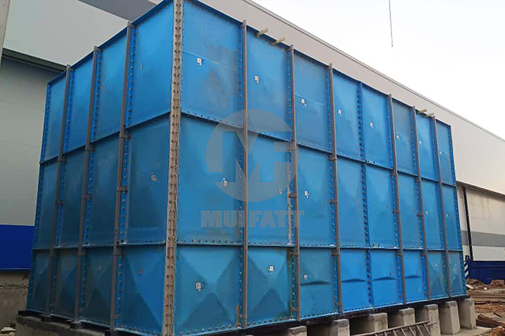 FRP sectional panel water tank fully assembled on cylindrical concrete plinths, installed beside a data center in Gelang Patah, Johor.
