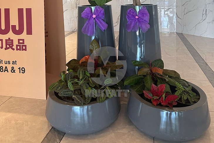 Close-up of Mui Fatt's grey FRP planter pots with vibrant indoor plants, adding aesthetic appeal to Sunway Carnival Mall’s interior landscaping.
