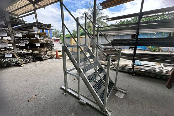 Fully assembled fiberglass-reinforced plastic staircase featuring molded grating and pultruded frame, staged for STP delivery in Sabah.