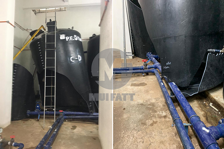 Indoor installation of closed-top PE water tanks showing tank rupture due to undersized concrete slab base, highlighting the importance of proper foundation design.