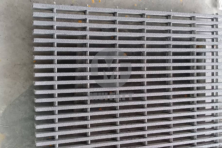 Close-up of non-slip pultruded FRP grating used in rooftop service platforms and industrial walkways