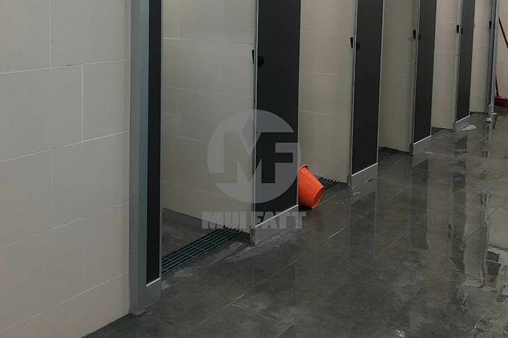 Toilet cubicles at RNR rest stop installed with grey molded FRP grating for hygienic water drainage and anti-slip safety